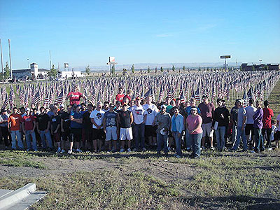 Supporters lined up in front of American flags at Crossroads Point's Patriot Day Healing Field