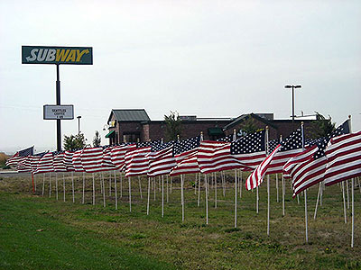 Crossroads Point's Patriot Day Healing Field with Subway in background