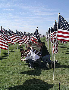 Kids raising American flag at Crossroads Point's Patriot Day Healing Field
